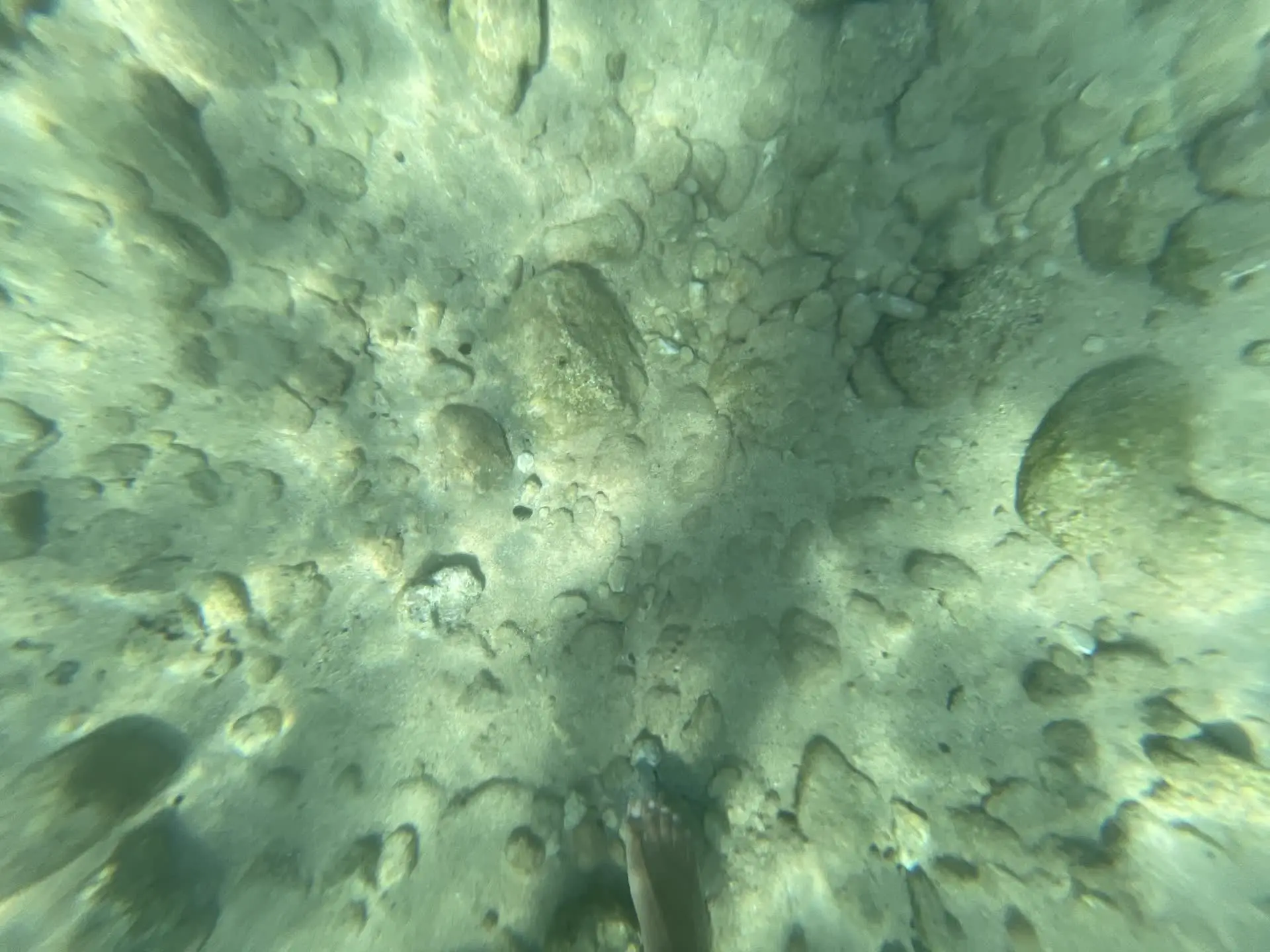 Stones and feet underwater